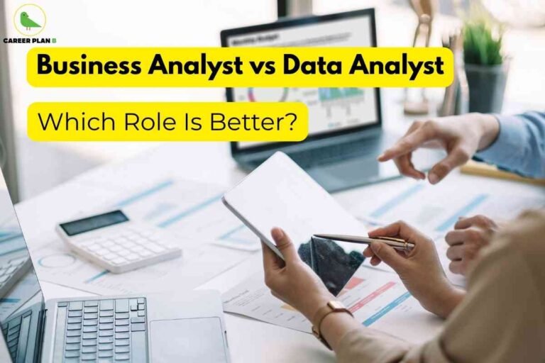 This image depicts a workplace scenario focused on analytics and professional roles. In the background, a laptop displaying graphs and charts on its screen sits on a desk covered with printed data sheets, a calculator, and a keyboard, all indicating a detailed data analysis or business review process. In the foreground, two hands are visible: one hand holds a stylus and points toward a tablet, while the other prepares to interact with the device, highlighting collaboration and the use of technology in analysis. Across the top of the image, bold black text sits inside a bright yellow banner, reading “Business Analyst vs Data Analyst.” Below, a second yellow banner contains the question, “Which Role Is Better?” signaling a direct comparison of these two career options. At the upper left, the “CAREER PLAN B” green bird logo serves as branding for career guidance. The scene collectively emphasizes decision-making and analytical responsibilities in a modern business or data environment.
