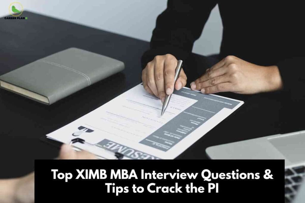 The image presents a close-up scene of a professional interview or discussion. Centered is a person's hand holding a pen, poised over a resume or application form attached to a clipboard. The other hand rests on the table near the document, suggesting an evaluative moment. On the left side of the table is a closed, grey notebook, and to the right, part of a silver laptop is visible. The background consists of a smooth, dark-colored surface and a pale wall. In the top left corner, the "Career Plan B" logo with a green bird silhouette and text is displayed. At the bottom, set against a black background, white bold text reads: "Top XIMB MBA Interview Questions & Tips to Crack the PI." The image clearly conveys preparation and strategy for MBA interviews, particularly at Xavier Institute of Management, Bhubaneswar (XIMB).