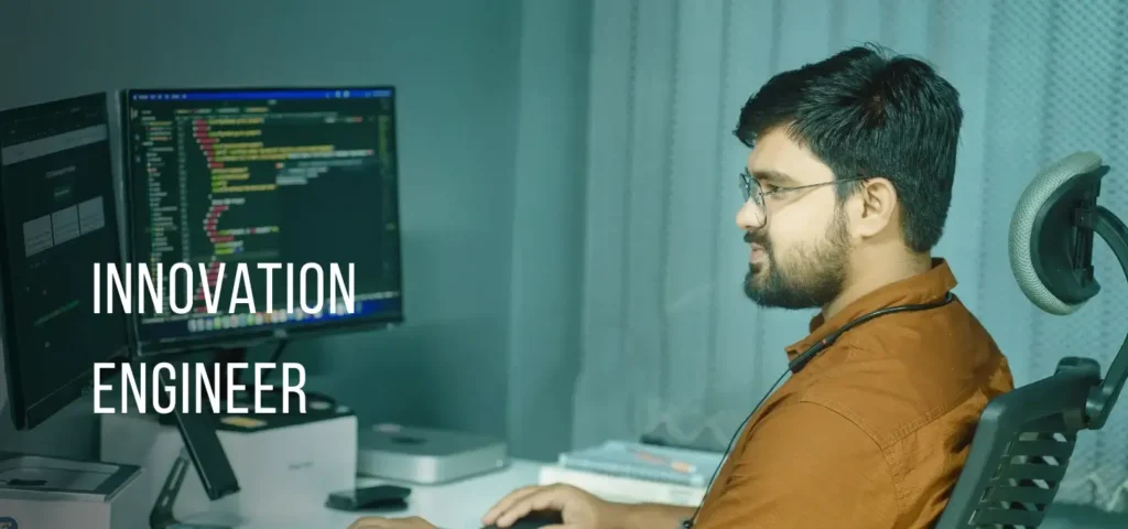 Innovation Engineer with glasses working at a dual-monitor setup with code on screen and "Innovation Engineer" text overlay.