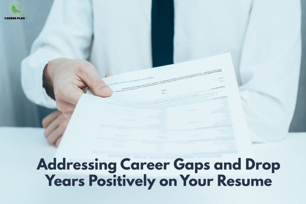 this image contains a Career Plan B educational banner showing a professional in a white shirt and black tie holding and reviewing printed documents, with the Career Plan B logo at the top left and the headline “Addressing Career Gaps and Drop Years Positively on Your Resume,” conveying resume guidance, career counselling, and professional development advice.