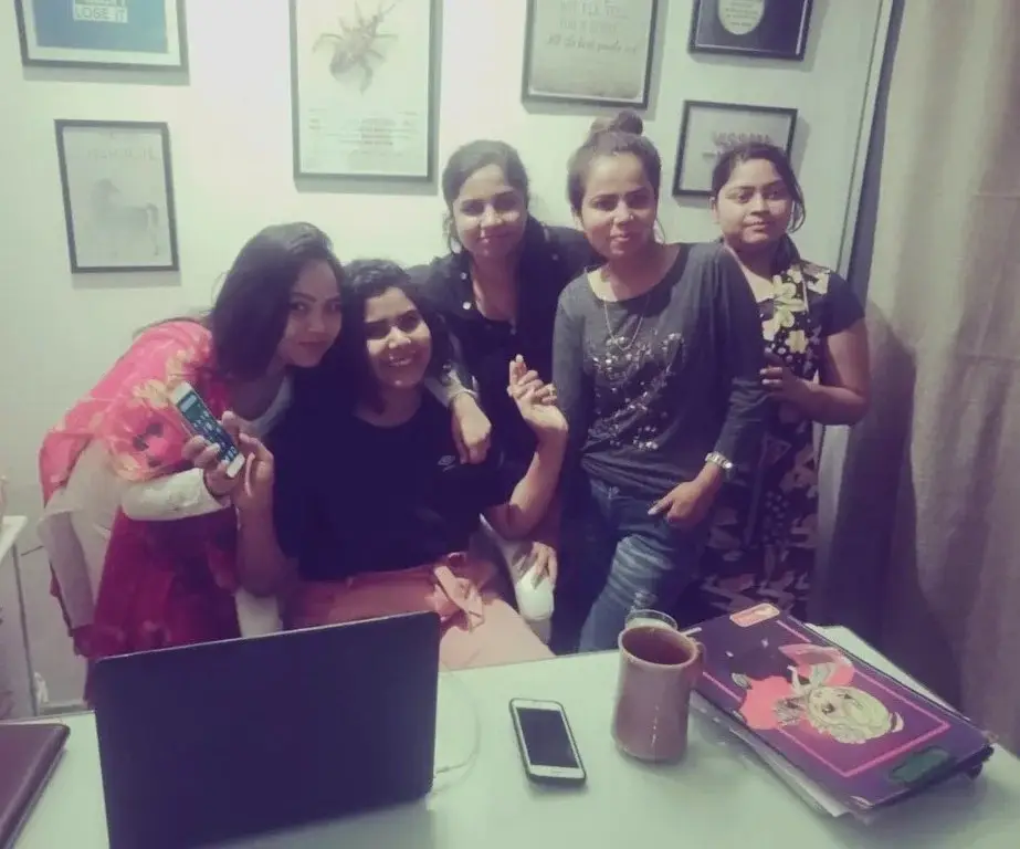 http://Career%20Plan%20B%20founders%20posing%20with%20a%20group%20of%20close%20friends%20at%20an%20desk%20featuring%20a%20laptop%20and%20framed%20wall%20art.