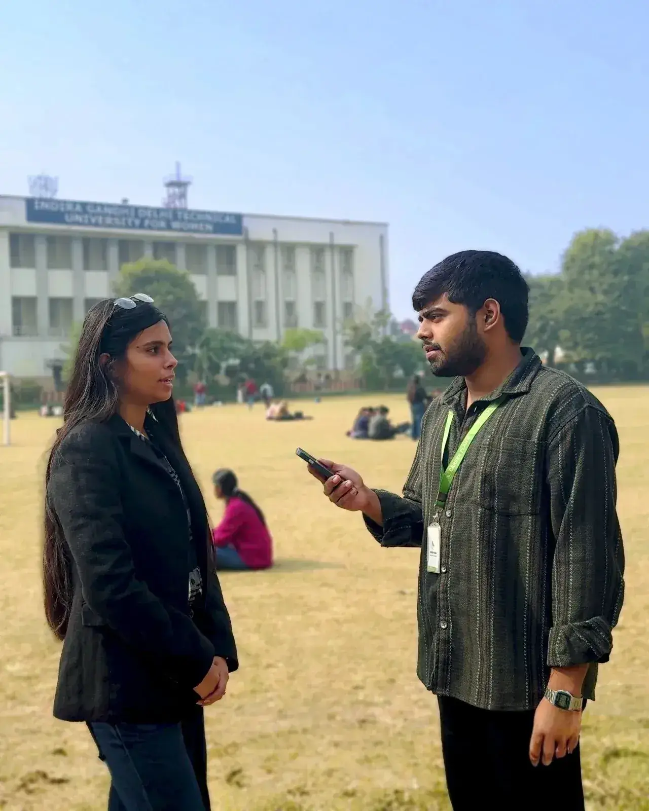 Career Plan B team member conducting academic counselling with a student on a university campus field.