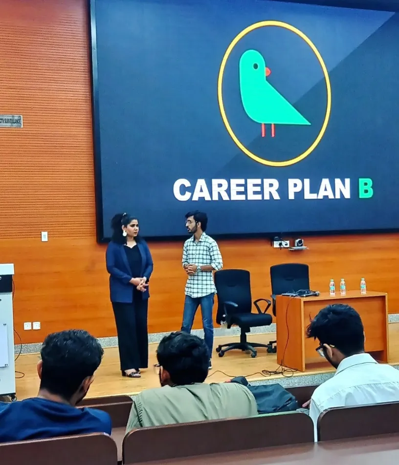 Career Plan B founder conducting career counselling for working professionals on stage in a large auditorium.