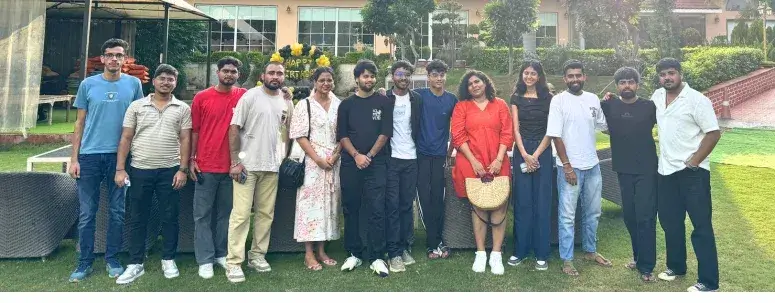 Career Plan B team standing together on a green lawn at an outdoor resort during a company retreat.